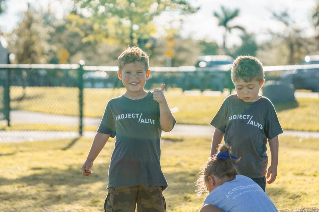 Children having fun and looking at the camera while at Petland puppy playdate.